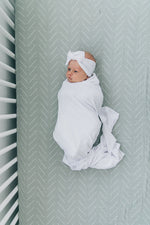 Mebie Baby White Stretch Swaddle. Mebie Baby Bamboo Stretch Swaddle. Gender Neutral for take home outfits and swaddling newborns.